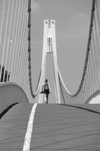 a man walking across a bridge 