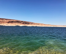 lake water and red rock cliffs 