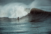 surfer braving a large wave