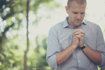 Man praying outside.
