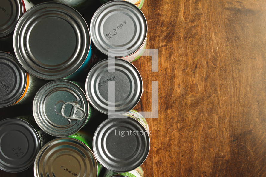Canned food sitting on a wood table