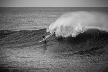 surfer braving large waves 
