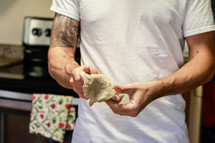 a man shaping dough in a kitchen 