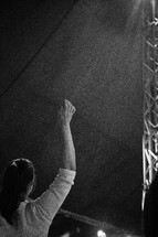 A woman with arms raised during a church service.
