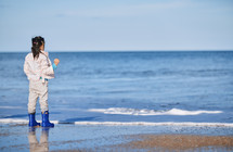 girl standing on a beach 
