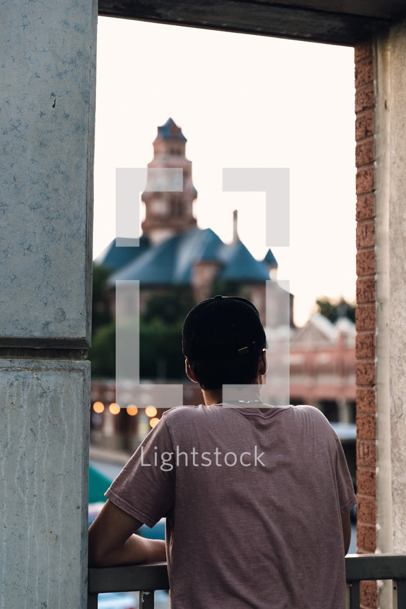 man looking over a railing 