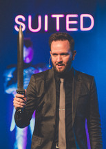 minster holding a sword during a worship service 