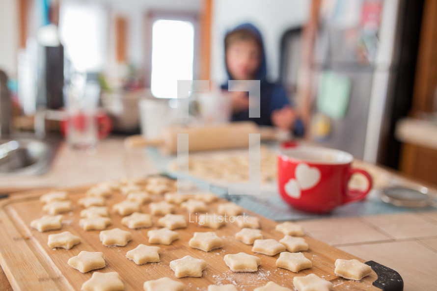 star shaped cookies and a kid in a kitchen 