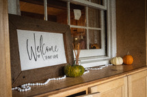 Welcome to our home sign and pumpkins 