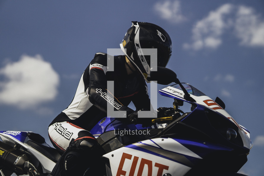 Yamaha R1 racing motorcycle, blue and white superbike, sports motorbike, female motorcycle rider in full leather protective gear