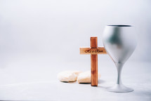 Matzos unleavened bread, chalice of wine, wooden cross on grey background. Christian communion for reminder of Jesus sacrifice. Easter passover. Eucharist concept. Christianity symbol and faith