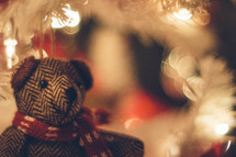 teddy bear under a Christmas tree
