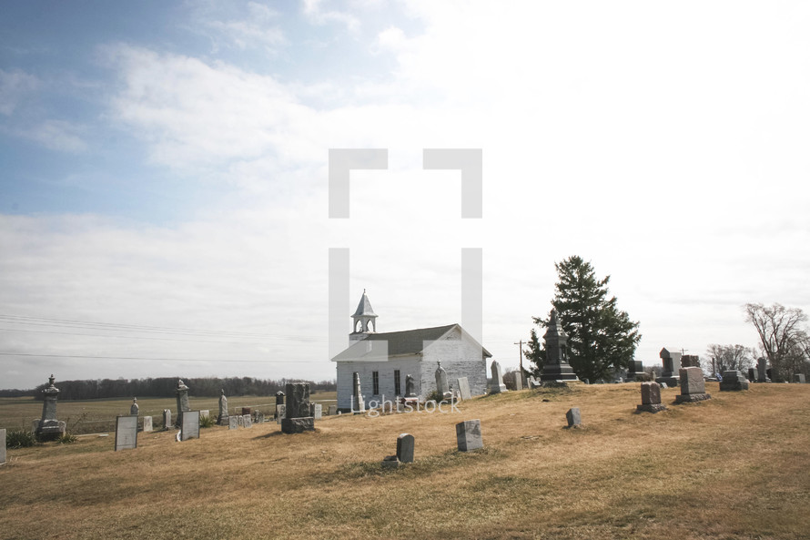 an old church surrounded by a cemetery 