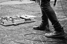 A man' foot near guitar pedals. 