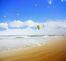 hot air balloons over a beach 