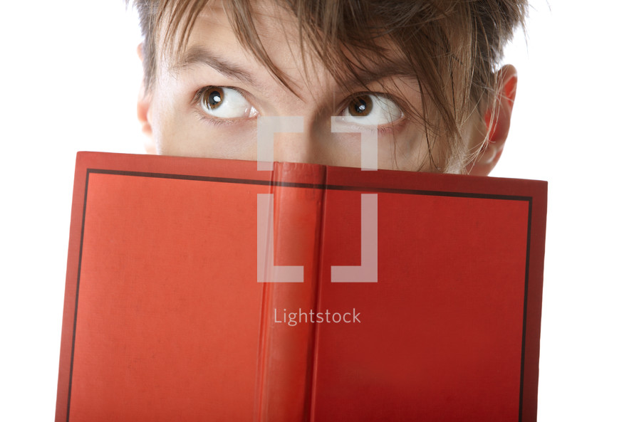 a man looking over a book 