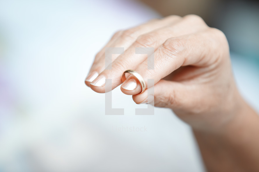 woman holding a wedding ring 