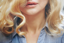 Close-up view on a blond woman with curly hair