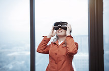 a woman in VR glasses looking up 