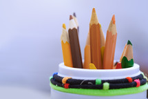 container of colored pencils 