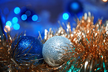 blue and silver ball ornaments on gold garland 