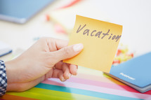 a woman holding a vacation note 