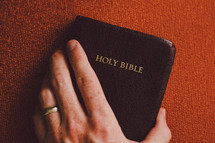 hand on a pocket Bible 