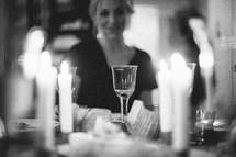 woman sitting at a dinner table 
