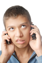 a boy talking on two cellphones 