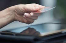 a woman paying online with a credit card