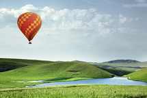 hot air balloon over green grass