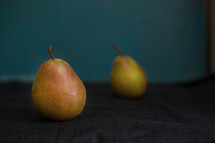 Two fresh pears on a table. Close-up view