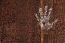 chalk handprint with heart on wood 
