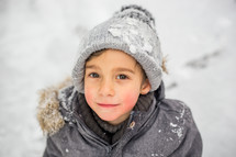 a boy playing in the snow 
