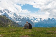 couple sitting on a mountaintop 