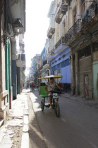pedicab driving on a narrow road 