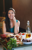 A woman sitting surrounded by healthy food 