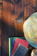 globe and book on a wood table 