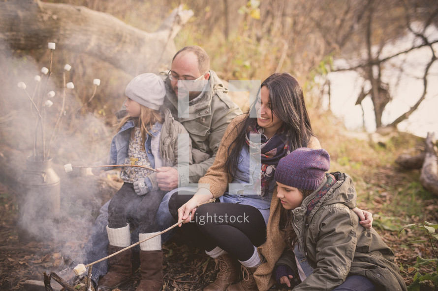 a family roasting marshmallows together 