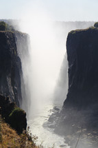 Mist from a waterfall in a ravine . Victoria Falls  and Zambezi River. 