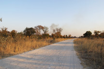 distant smoke from a dirt road 