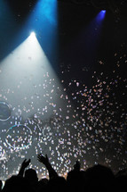 bubbles under a spotlight at a concert 