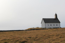 simple church building along a shore 