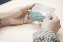 a woman holding credit cards 