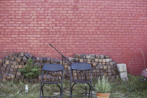 folding chairs in front of an old brick building 