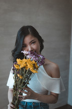 a young woman holding flowers 