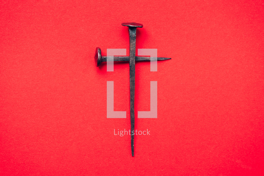 Cross made from nails on a red background - Good Friday