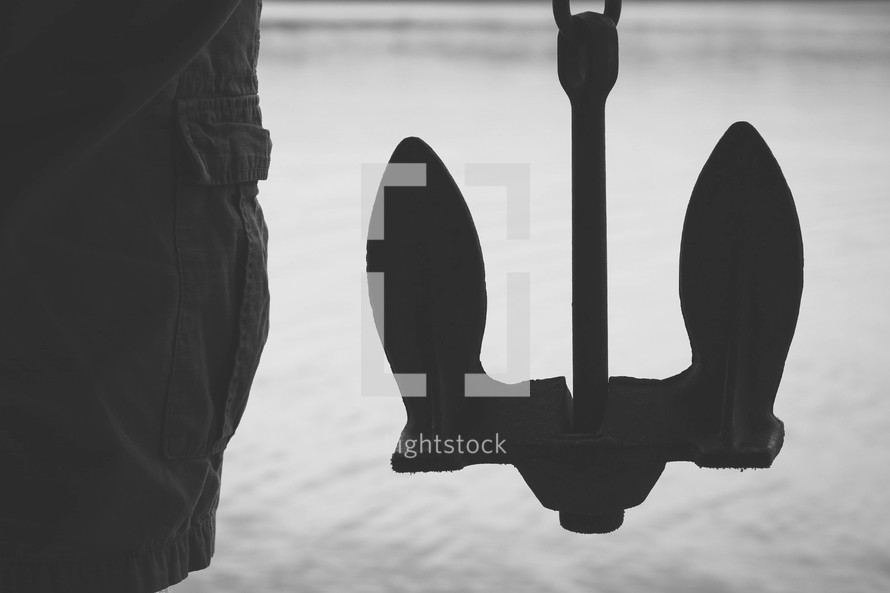 silhouette of a man and an anchor 