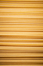 A pile of spaghetti dry on the table. Against a dark background. High quality photo