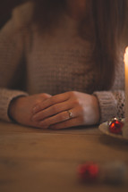 a woman praying over a table at Christmas 